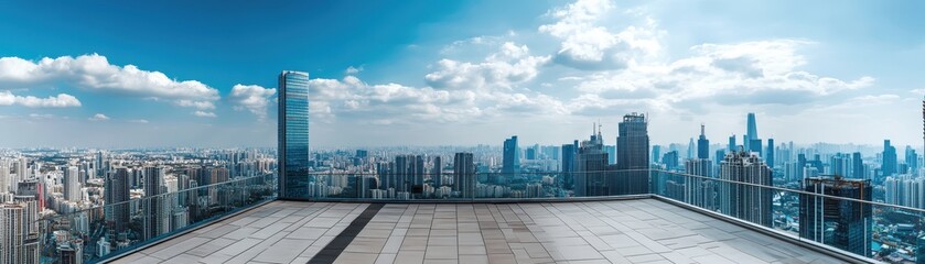 Obraz premium Panoramic cityscape view from a rooftop with modern skyscrapers under a bright blue sky with scattered clouds.