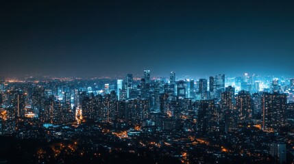 Panoramic night view of a vibrant cityscape with illuminated skyscrapers and buildings under a clear, dark blue sky.
