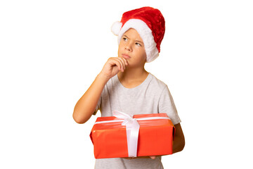 portrait of a pensive child boy holding a new gift isolated over transparent background.