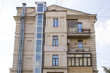 A building that has an external elevator located on the side of its structure, giving it a unique architectural design.