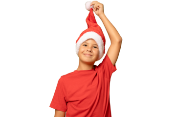 Portrait of a beautiful smiling boy in a red hat and red t-shirt on a transparent background. A child in a Christmas hat of Santa Claus.