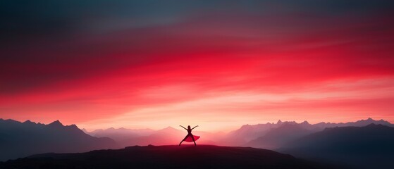 Silhouette of a person celebrating on a hilltop against a dramatic red sunset sky, ideal for inspirational and nature-related themes.