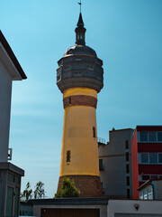 Obraz premium water tower with an old construction, on a clear sky with a yellow column