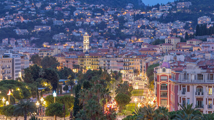 Evening aerial panorama of Nice day to night timelapse, France. Lighted Old Town little streets and Massena square after sunset