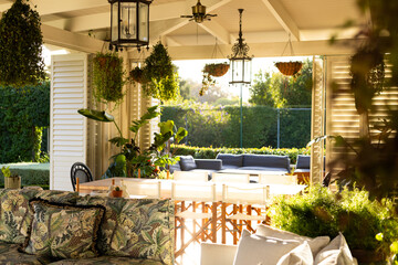 Sunlit patio with lush plants and comfortable seating for family relaxation