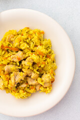 Stewed rice with chicken breast and mixed salad with radishes and various seeds, a delicious hearty lunch or dinner