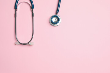 Fototapeta premium Stethoscope on pink background, top view. Space for text