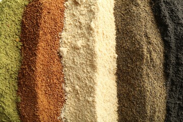 Different superfood powders as background, closeup view