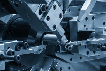 Close up the coil spring machine in light blue scene.
