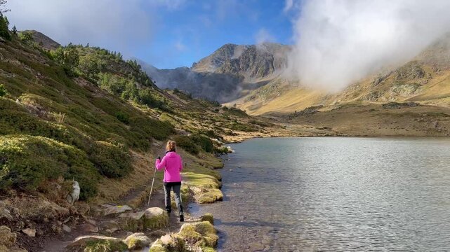 Autumn hike to Carlit Peak, France, featuring a girl at the summit with breathtaking mountain views.