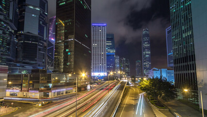 Fototapeta premium Hong Kong Business District with busy traffic timelapse at night.
