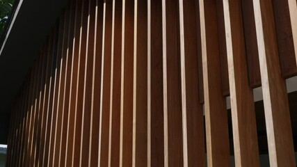 Vertical wooden panels in dark brown colour with holes between for creative decoration of external wall. Exterior of new house covered with natural tree - Powered by Adobe