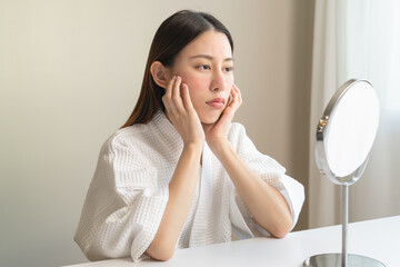 Dermatology, puberty asian young woman, girl looking into mirror, allergy presenting an allergic...