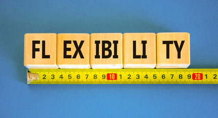 Flexibility symbol. Concept word Flexibility on beautiful wooden blocks. Beautiful blue background....