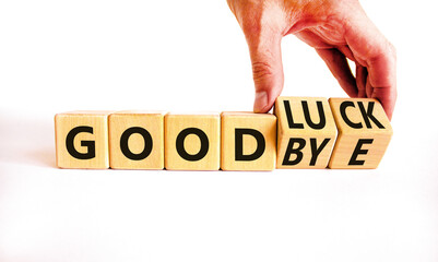 Good luck or goodbye symbol. Concept words Good luck or Goodbye on beautiful wooden blocks. Beautiful white background. Businessman hand. Business, motivational good luck concept. Copy space.