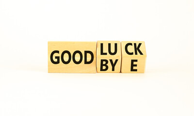 Good luck or goodbye symbol. Concept words Good luck or Goodbye on beautiful wooden blocks. Beautiful white table white background. Business, motivational good luck concept. Copy space.