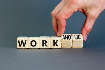 Work or workaholic symbol. Concept words Work or Workaholic on wooden cubes. Beautiful grey table grey background. Businessman hand. Business work or workaholic concept. Copy space.