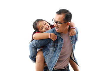 Happy man carrying his sweet beautiful 7 years old daughter on his back. Isolated on white