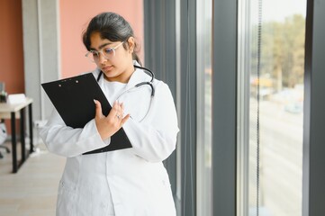 Medical concept of Indian beautiful female doctor in white coat with stethoscope. Medical student