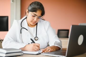 Medical concept of Indian beautiful female doctor in white coat with stethoscope. Medical student