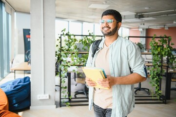 Happy indian male student at the university