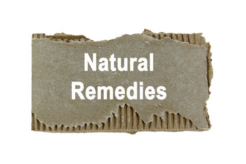 Natural remedies wording or text on ripped paper edge cardboard with white background.Copy space and business concept.