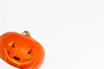 Funny carved Halloween pumpkin on white background