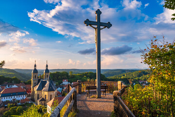 View of Gößweinstein in Franconian Switzerland from a viewpoint with a cross at sunset