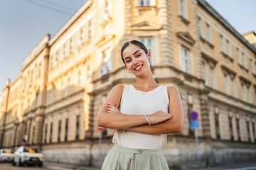 Fototapeta premium Portrait of beautiful happy young woman stand on the street