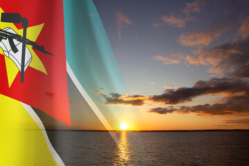 Flag of Mozambique against the sunset