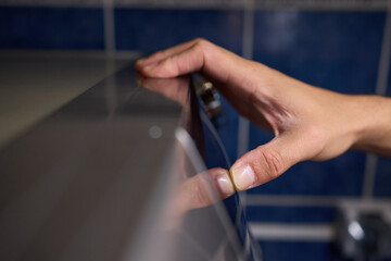 Hands Skillfully Adjusting the Washer Control in a Modern Domestic Laundry Room Environment