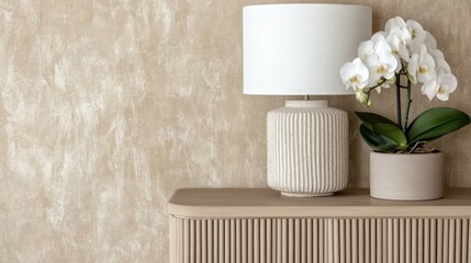 A stylish wooden sideboard is placed against a beige wall, adorned with a white lamp and a mock-up...