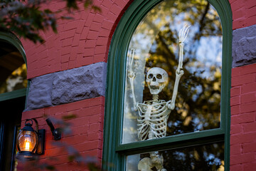 Halloween window decorations. Halloween pumpkin and skeleton for decorated house. Scary Decorated...