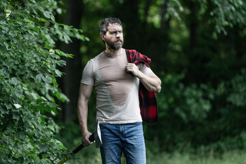 Lumberjack sweating after hardworking. Brutal lumberjack. Brutality and masculinity. Sweating...