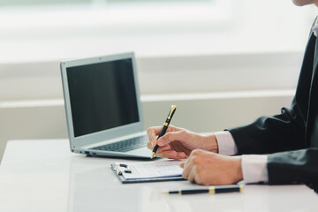 Businessman, house and condo sales agent, handing over keys to clients and signing sales or rental agreements at the office. Real estate business concept.