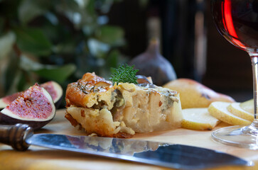 Homemade pie, pears and figs with a glass of wine.