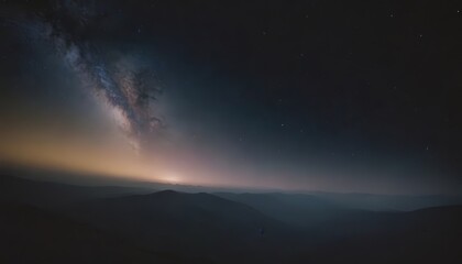 A dark sky with a milky way galaxy above a mountain range,  with a slight hint of orange glow from the horizon.