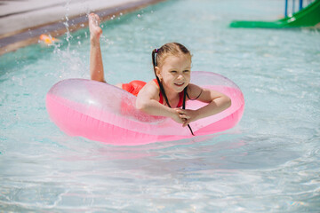 Young Girl Enjoying Pool on Inflatable Ring