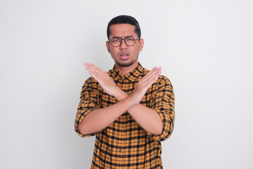 A man doing cross hand sign and showing worried expression