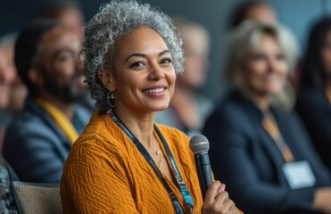 Fototapeta premium A diverse audience listens to a woman speaking on marketing at a business conference