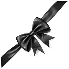 Beautiful large black shiny bow with diagonal ribbon and soft shadow on white background.