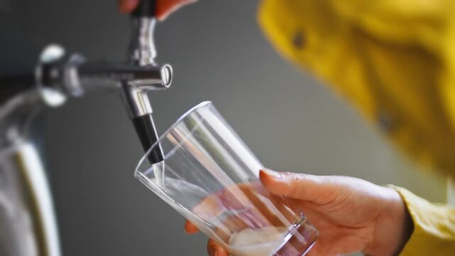 Pouring craft beer into a glass from a keg.