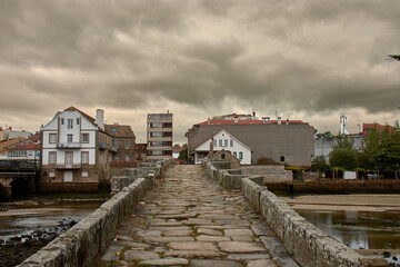 Historic romanesque bridge of Santa Cristina de la Ramallosa crossing the Miñor river