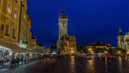 Fototapeta premium Prague Old Town Hall at Night timelapse hyperlapse with unrecognizable tourists walking