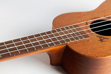 Obraz premium acoustic Ukulele Hawaiian Guitar. a wooden ukulele with strings. musical instrument isolated on white background