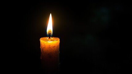 A single candle, glowing brightly against the darkness of night, symbolizes hope and light in times of melancholy.  