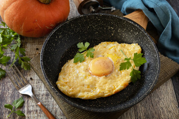 Khachapuri, baked cottage cheese pumpkin bread with cheese and egg filling on rustic wooden table.