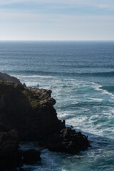 fisherman, waves and rocks
