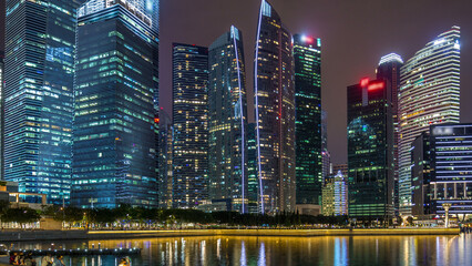 Singapore business district skyscrapers in the night time with water reflections timelapse hyperlapse