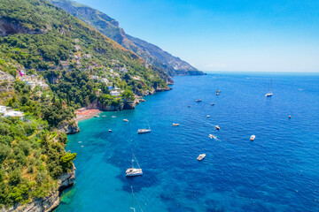 Positano town, beach and beautiful colorful houses on the cliff in Amalfi coast in Italy